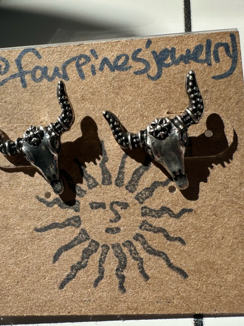 Western longhorn cow/bison/steer skull stud earrings in silver.